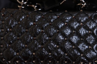 Texture of black leather bag as background, top view