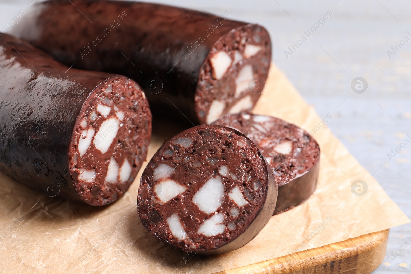 Photo of Tasty blood sausage on grey table, closeup