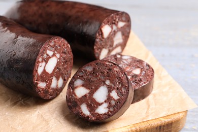 Tasty blood sausage on grey table, closeup