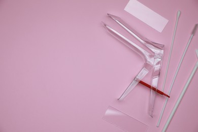 Photo of Sterile gynecological examination kit on pink background, flat lay. Space for text