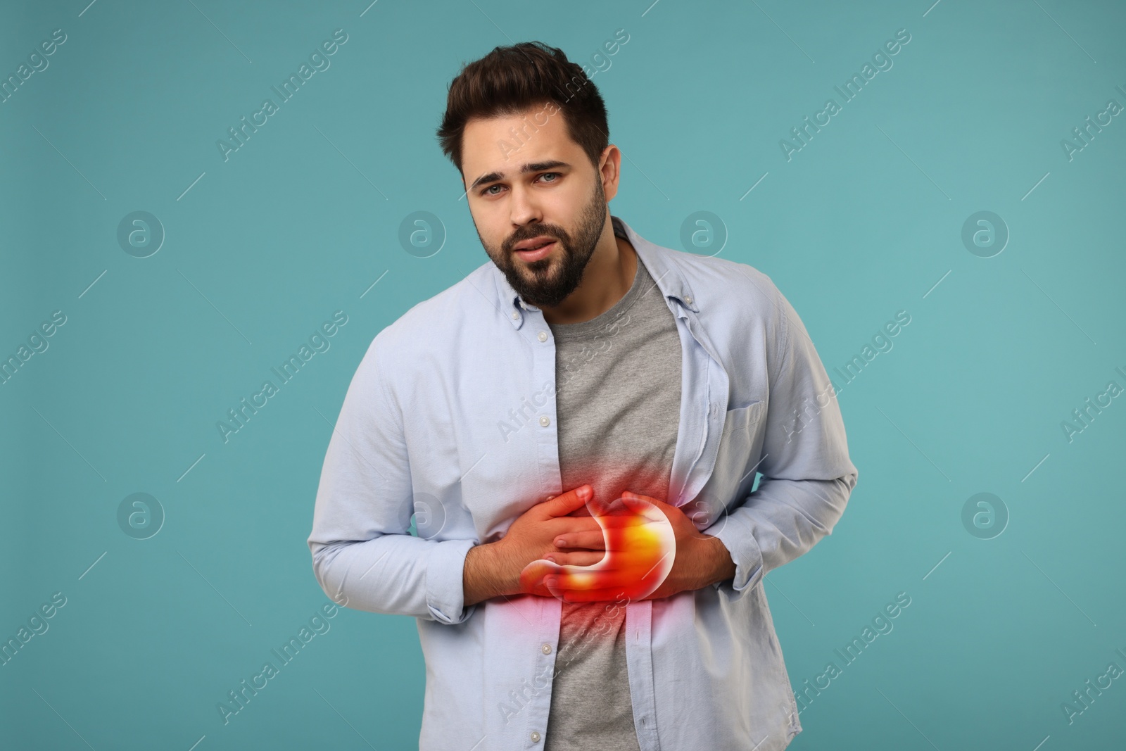 Image of Man suffering from abdominal pain on light blue background. Illustration of unhealthy stomach