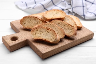 Tasty hard chuck crackers on white wooden table