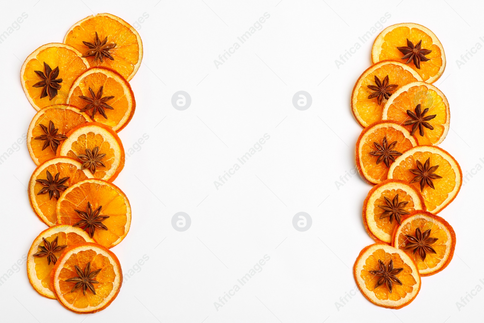 Photo of Flat lay composition with dry orange slices and anise stars on white background. Space for text