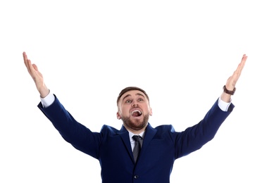 Young businessman under rain of money on white background