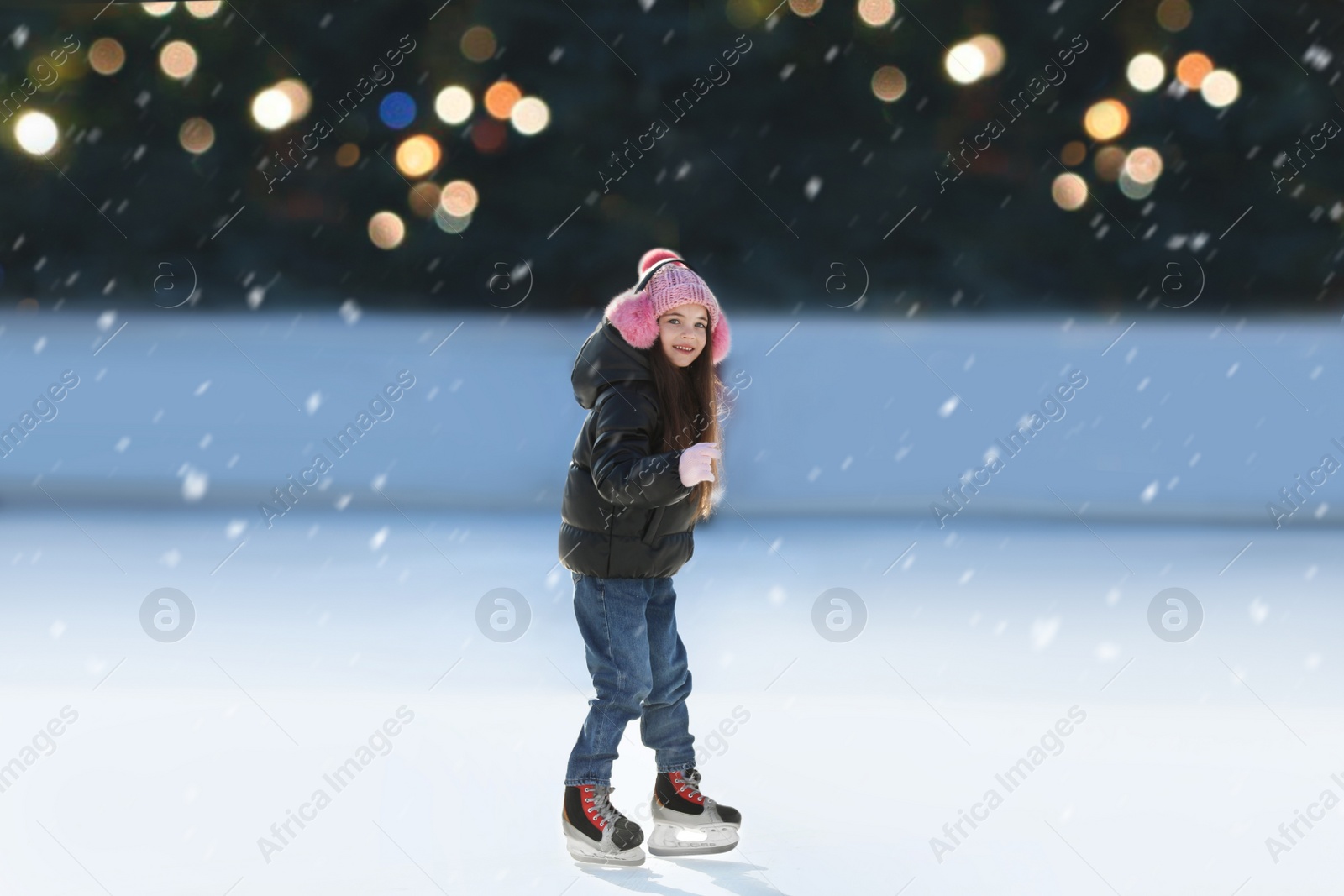 Image of Cute little girl at outdoor ice skating rink