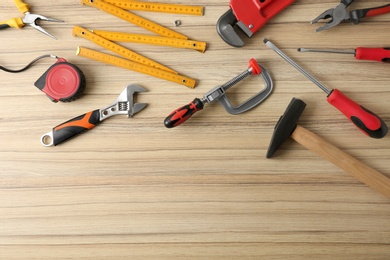 Photo of Flat lay composition with repair tools on wooden table, space for text