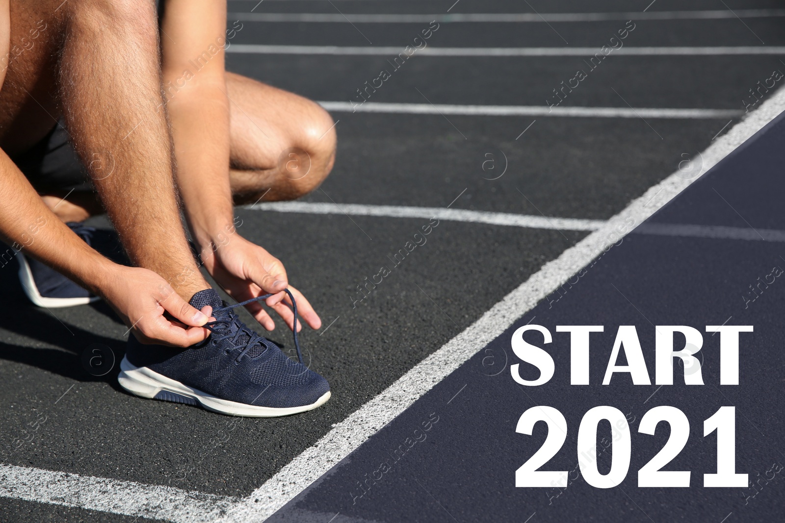 Image of Sporty man tying shoelaces in front of starting line with text Start 2010 at stadium, closeup