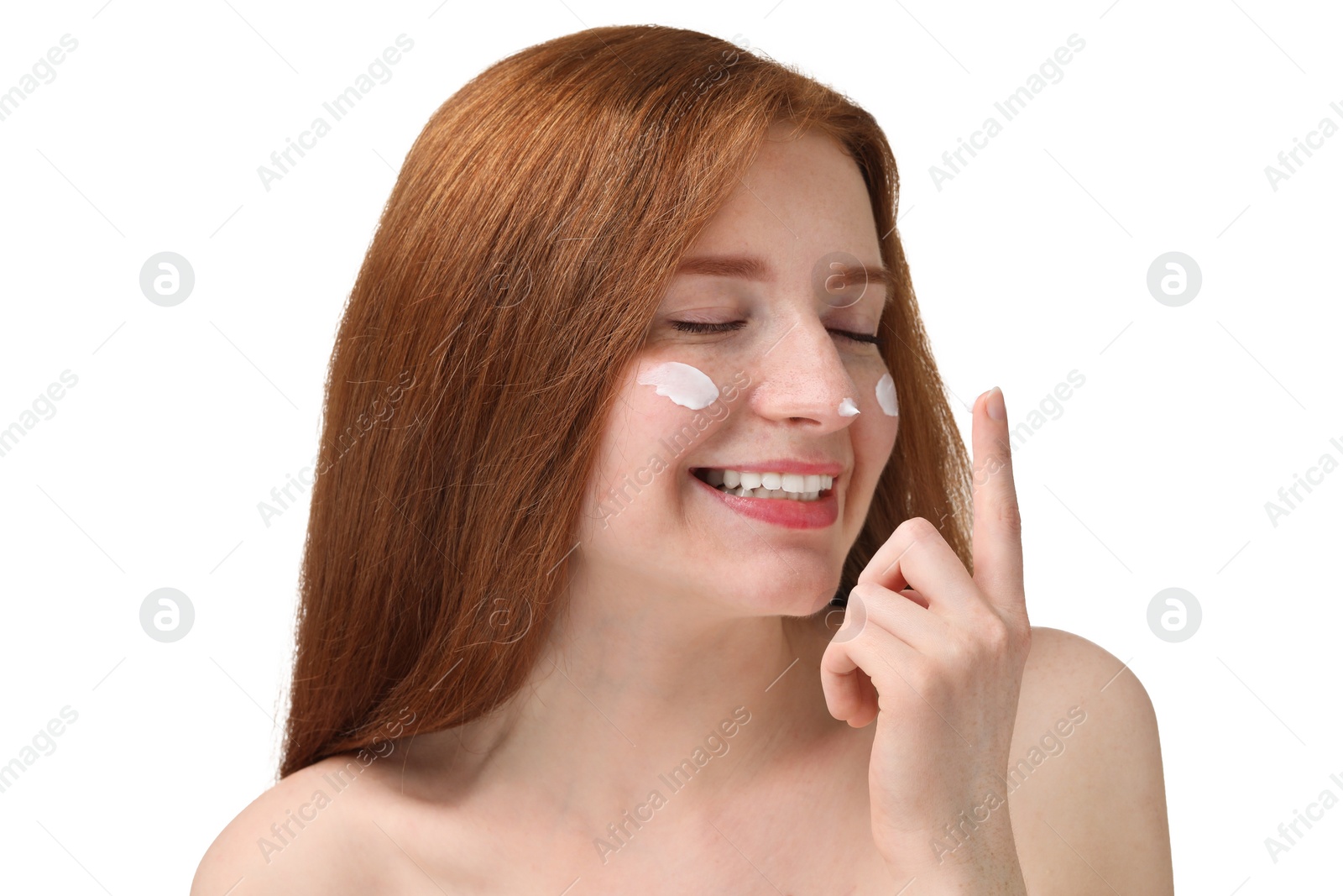 Photo of Smiling woman with freckles and cream on her face against white background, closeup