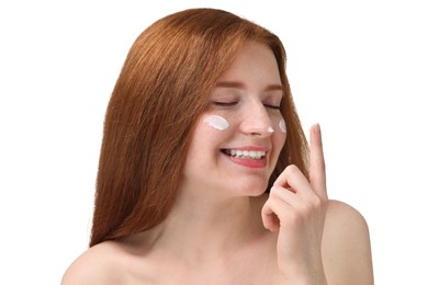 Smiling woman with freckles and cream on her face against white background, closeup