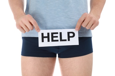 Man holding paper with word HELP on white background, closeup. Urology problems