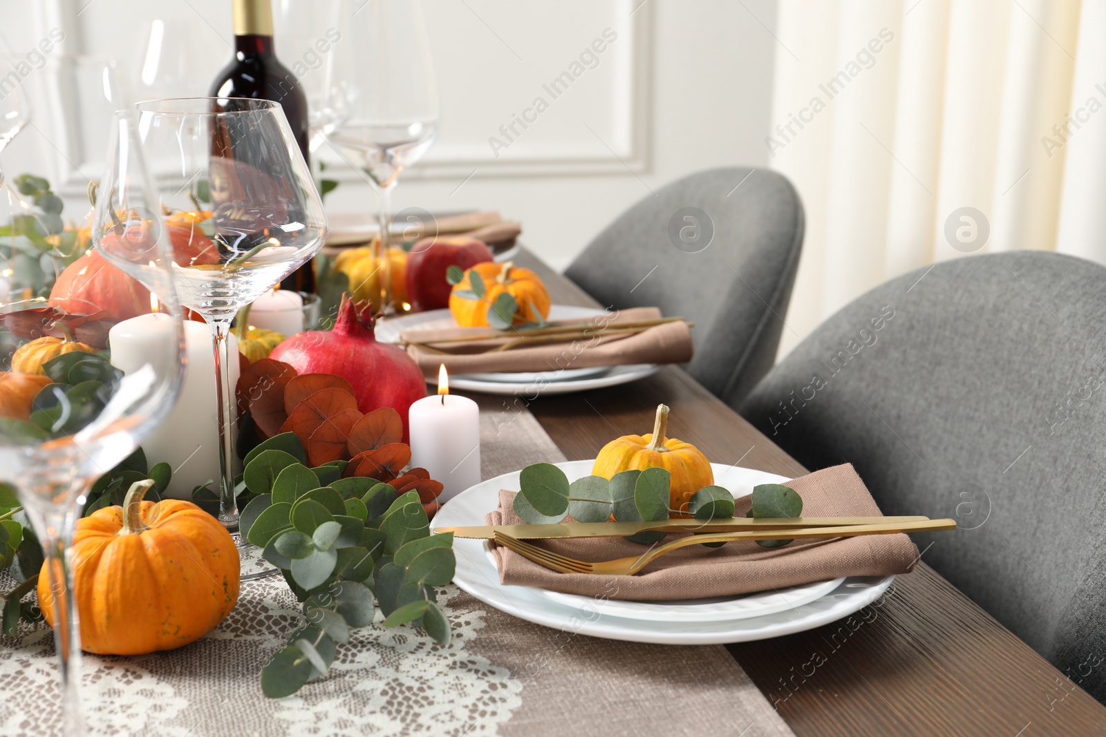 Photo of Beautiful autumn table setting. Plates, cutlery, glasses, pumpkins and floral decor