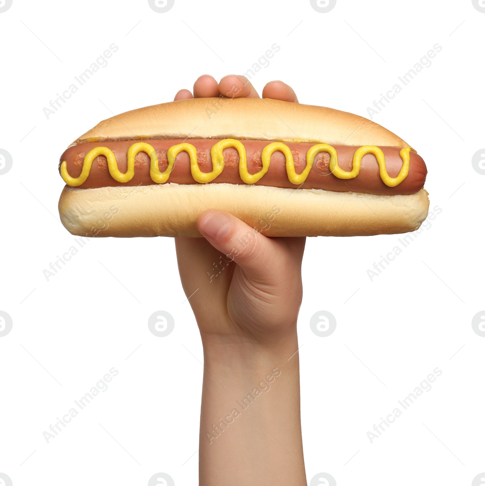 Photo of Woman holding delicious hot dog with mustard on white background, closeup