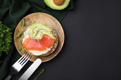 Photo of Crunchy buckwheat cakes served with cream cheese, salmon and avocado on table, flat lay. Space for text