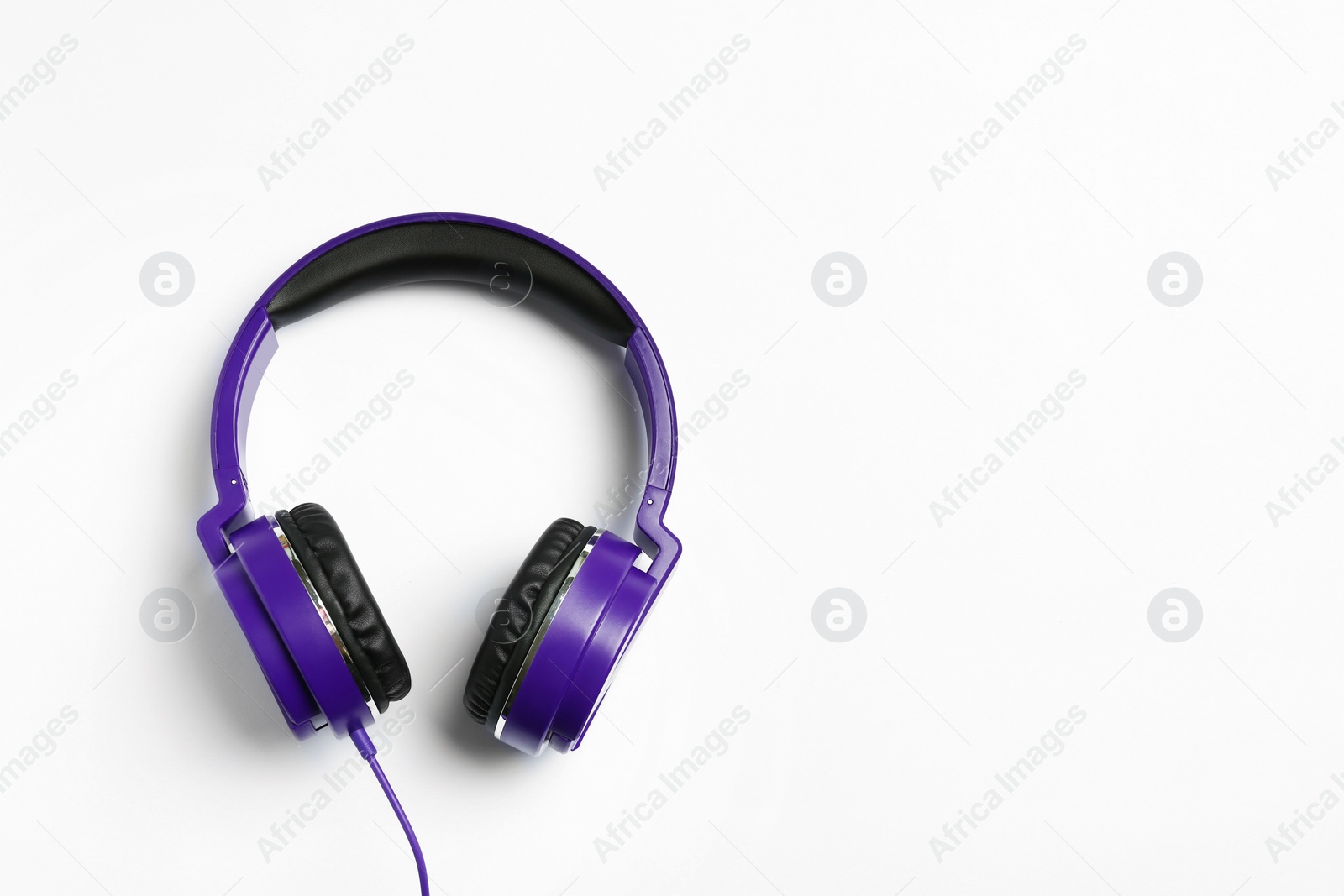 Photo of Stylish modern headphones on white background, top view