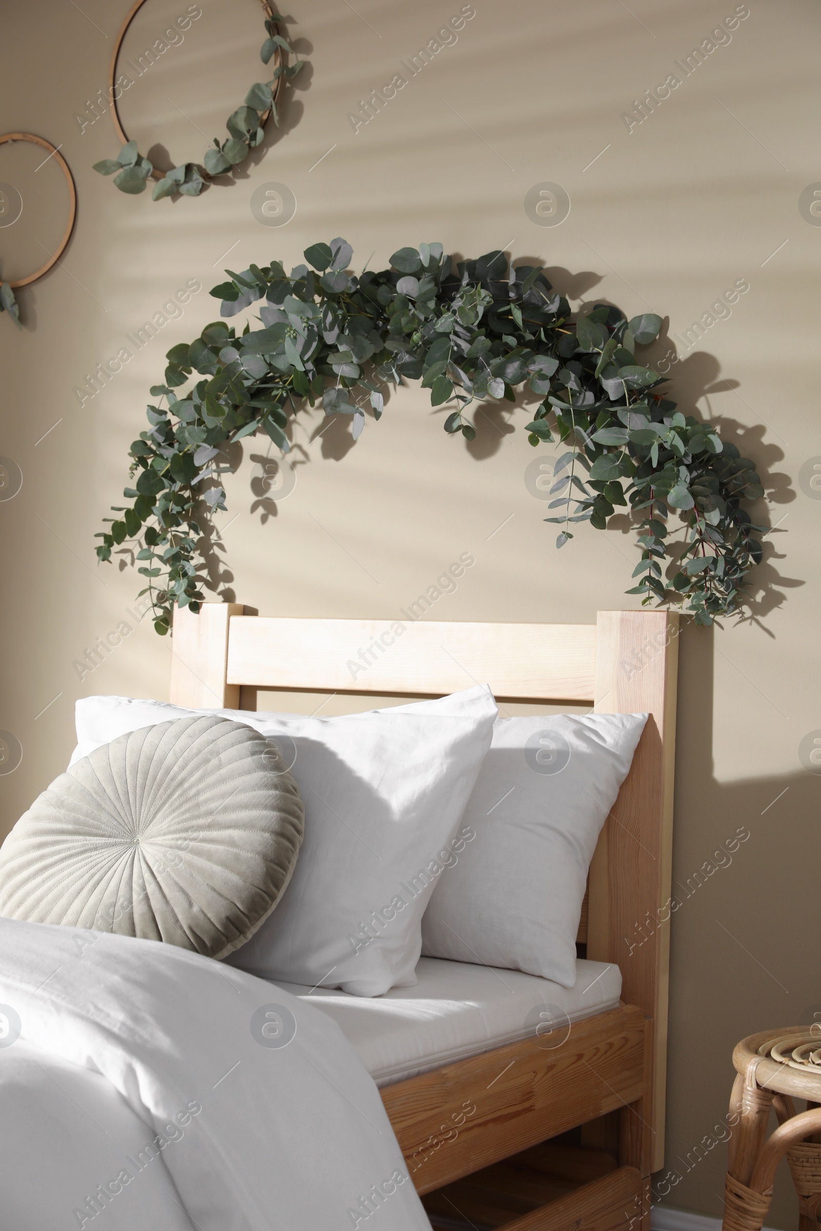 Photo of Stylish bedroom decorated with beautiful eucalyptus garland