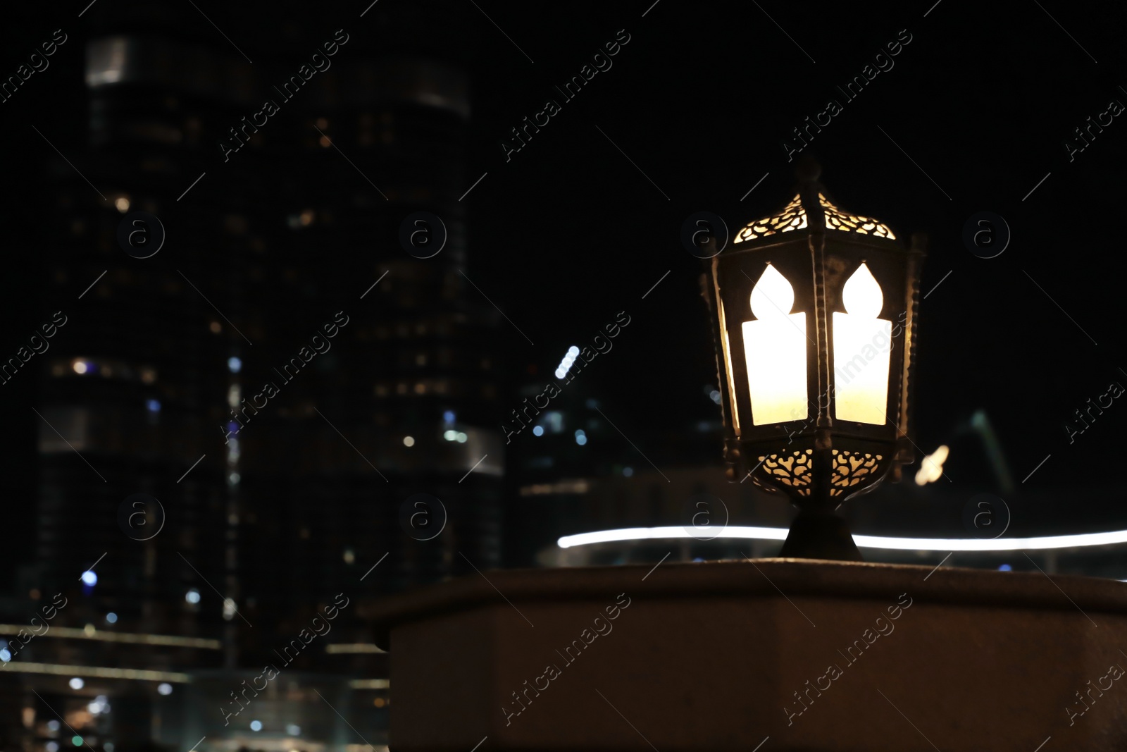 Photo of DUBAI, UNITED ARAB EMIRATES - NOVEMBER 04, 2018: Street lantern against blurred cityscape, space for text