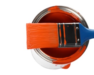 Photo of Can of orange paint and brush on white background, above view