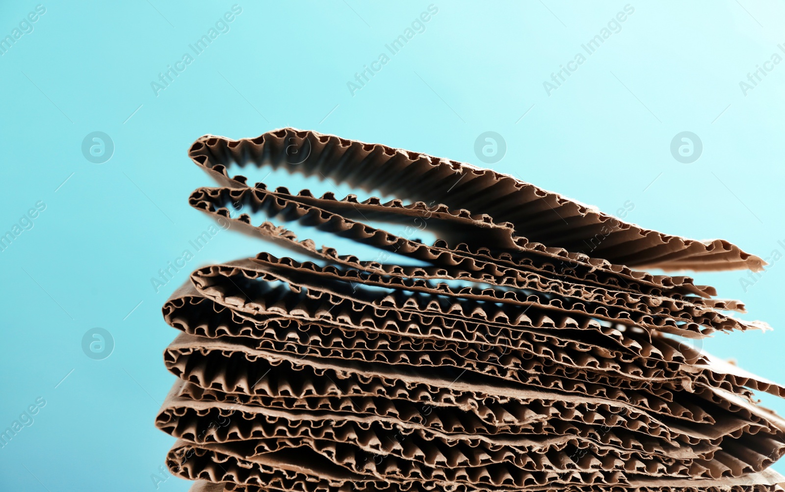 Photo of Stack of cardboard for recycling on color background