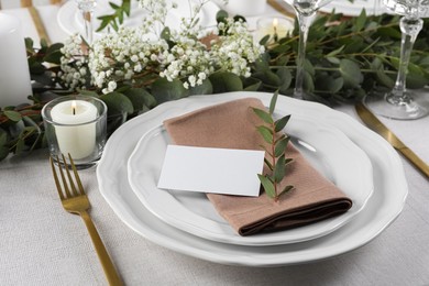 Luxury table setting with beautiful decor and blank card. Festive dinner