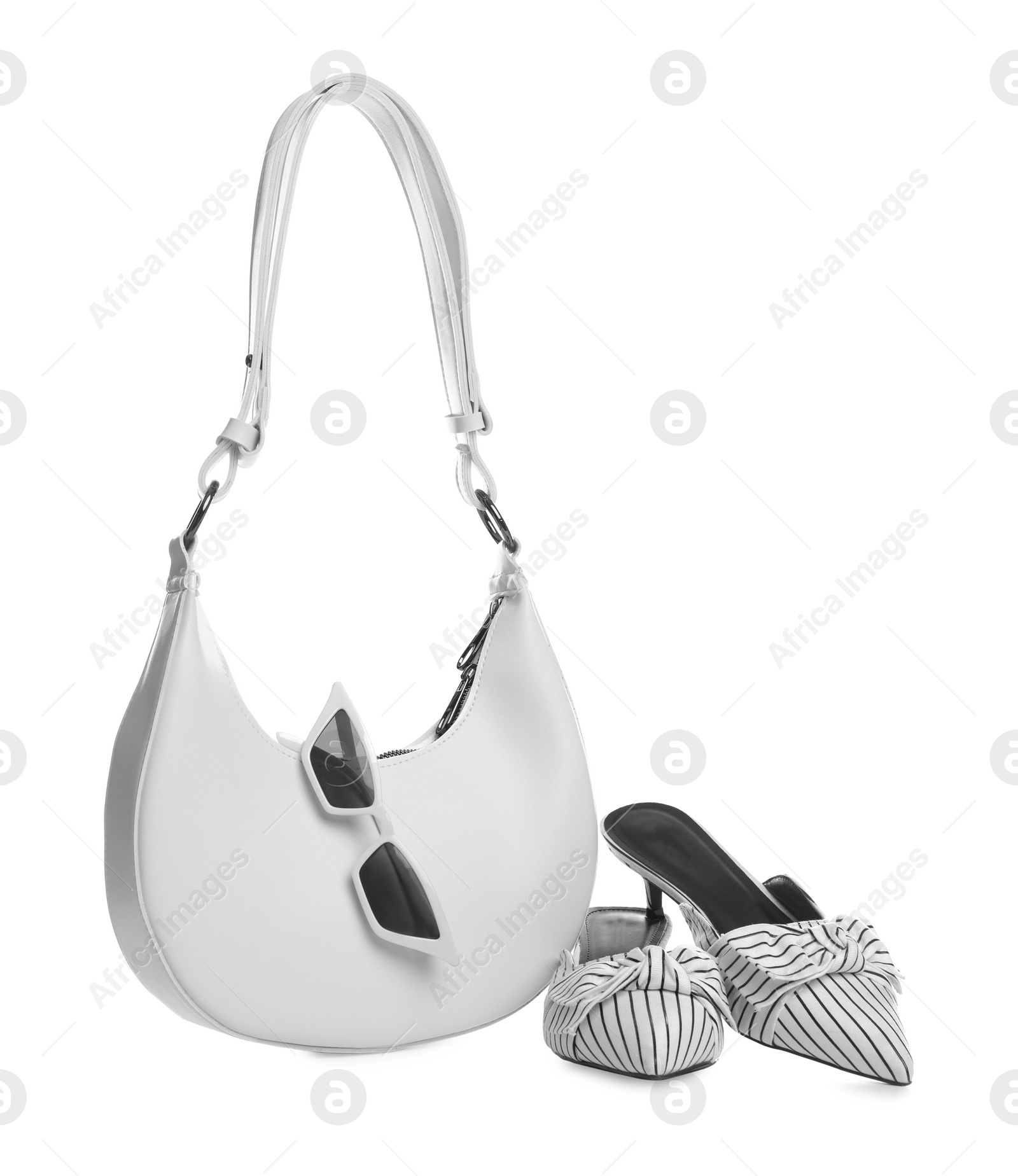 Photo of Stylish woman's bag, sunglasses and shoes isolated on white