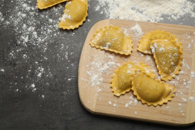 Photo of Flat lay composition with raw ravioli on grey table. Italian pasta