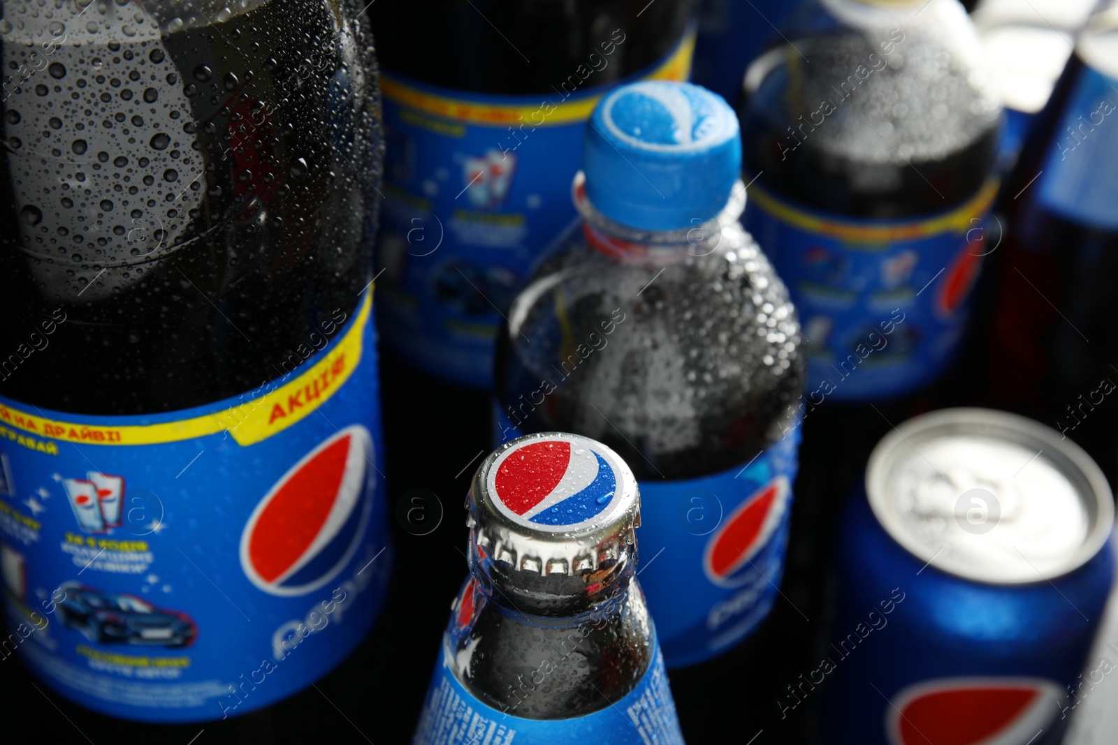 Photo of MYKOLAIV, UKRAINE - FEBRUARY 9, 2021: Many different bottles of Pepsi, closeup