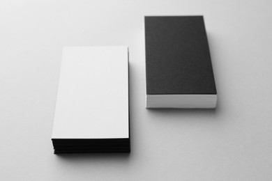 Blank black and white business cards on light background. Mockup for design