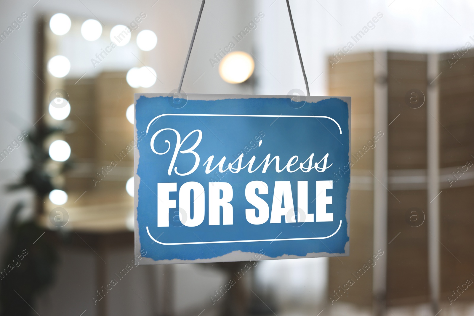 Image of Light blue sign with Business For Sale hanging on glass door