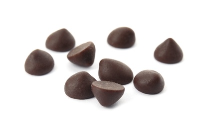 Photo of Pile of delicious dark chocolate chips on white background