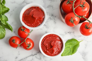 Photo of Flat lay composition with tasty homemade tomato sauce on marble background