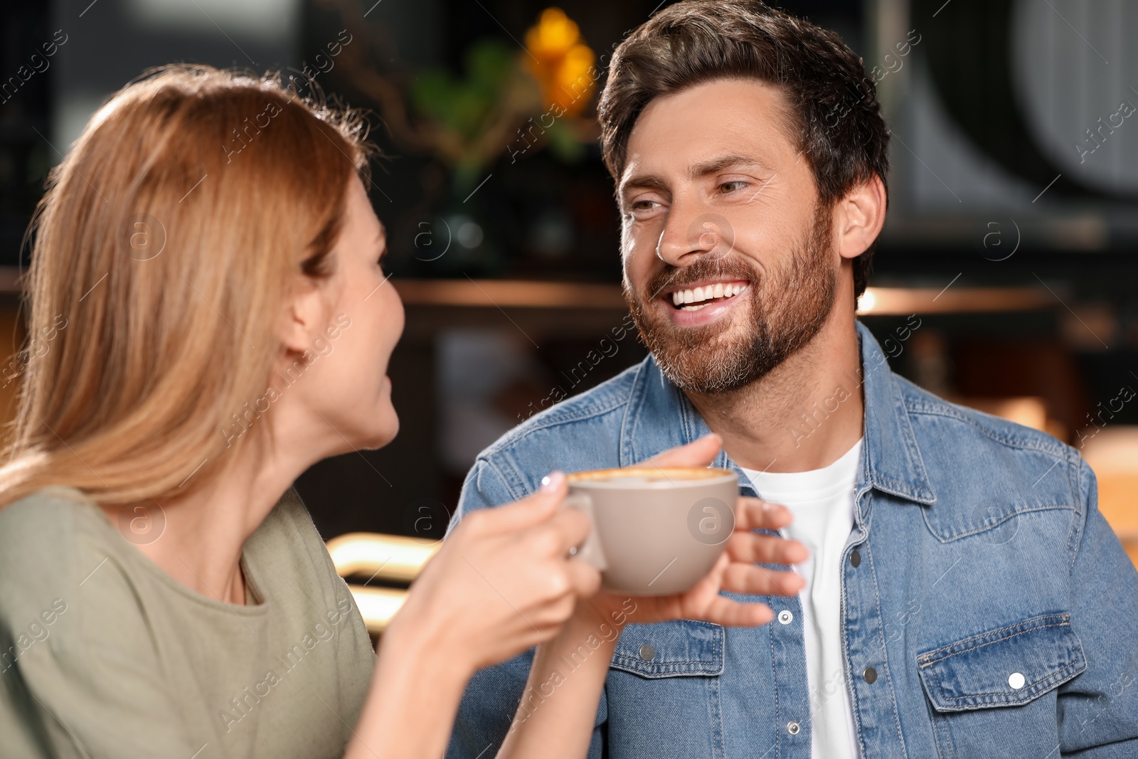 Photo of Romantic date. Happy couple spending time together in cafe