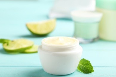 Photo of Jar with cream on wooden background. Hand care cosmetics