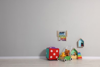 Photo of Beautiful children's room with grey wall and toys, space for text. Interior design