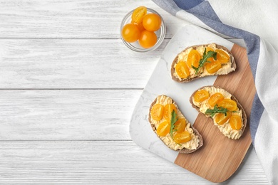 Photo of Tasty fresh tomato bruschettas on white wooden table, flat lay. Space for text