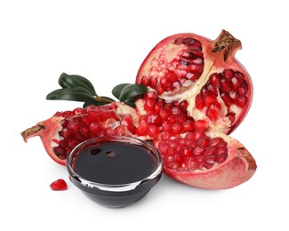 Photo of Tasty pomegranate sauce in bowl, leaves and fruits isolated on white