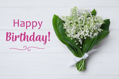 Image of Happy Birthday! Beautiful lily of the valley flowers on white wooden table, top view 