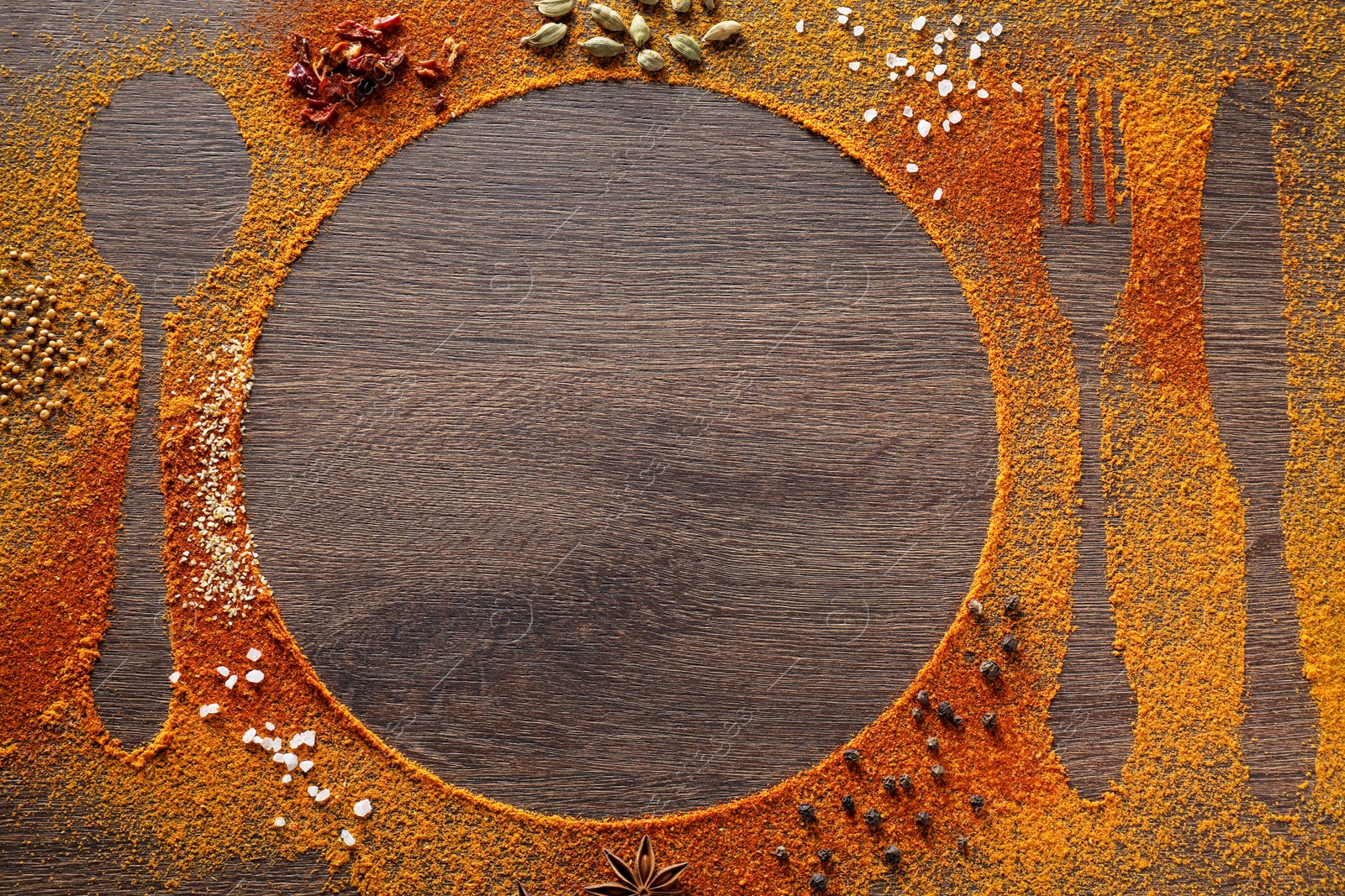 Photo of Silhouettes of cutlery and plate made with spices on wooden table, flat lay. Space for text