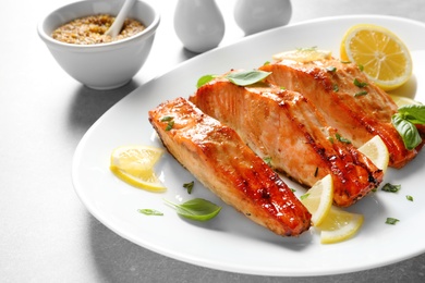 Photo of Plate with tasty freshly cooked salmon, closeup