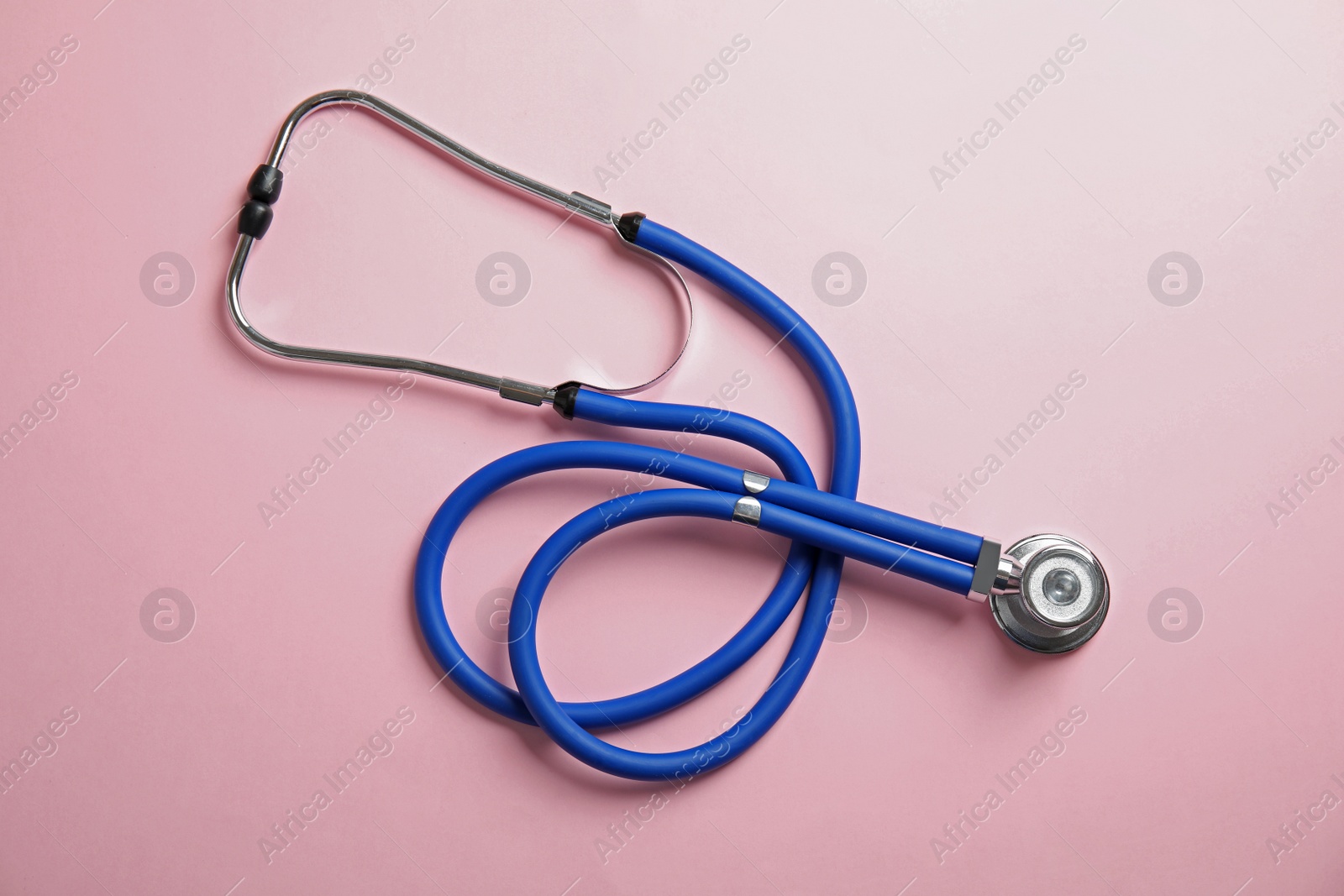 Photo of Stethoscope on color background, top view. Medical tool