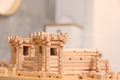 Wooden construction set on table indoors, space for text. Children's toy