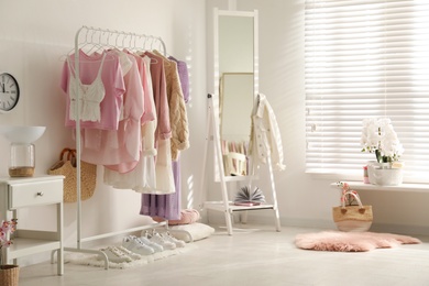 Dressing room interior with clothing rack and mirror