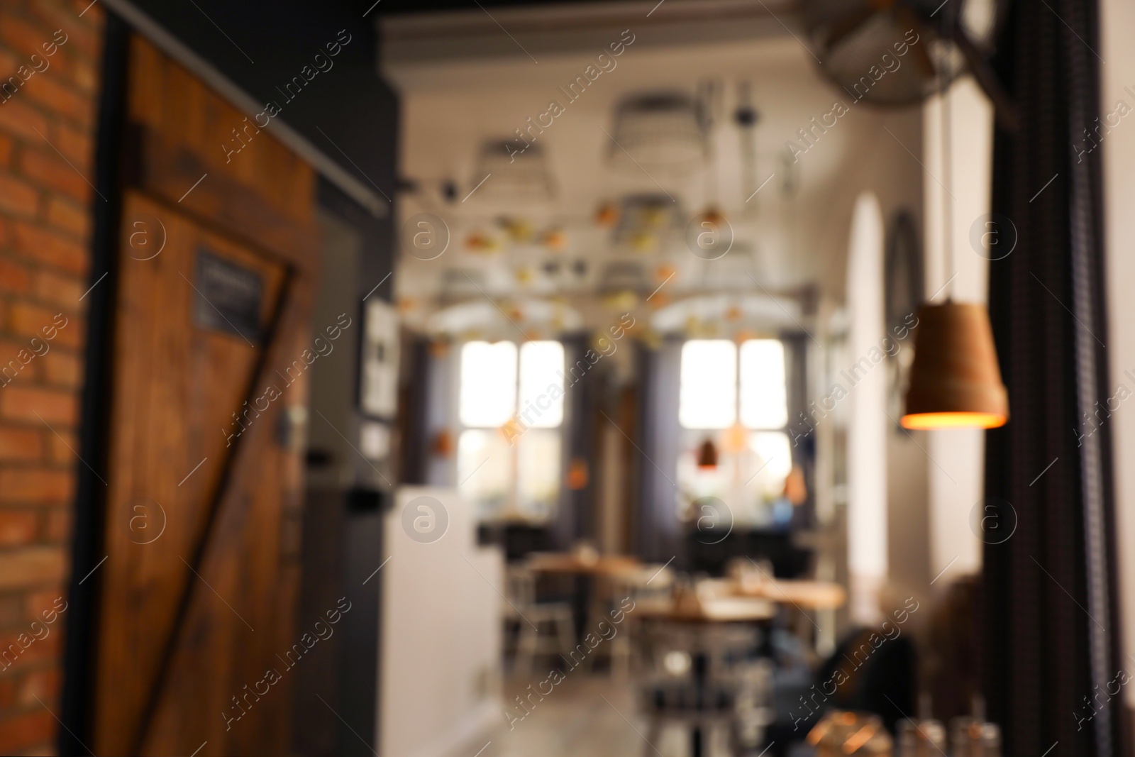 Photo of Stylish cafe interior with furniture, blurred view