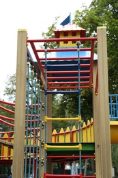 Photo of Children's playground with climbing rope ladder on summer day