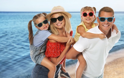 Image of Happy family on sandy beach near sea. Summer vacation