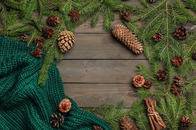 Photo of Flat lay composition with pinecones on wooden background. Space for text