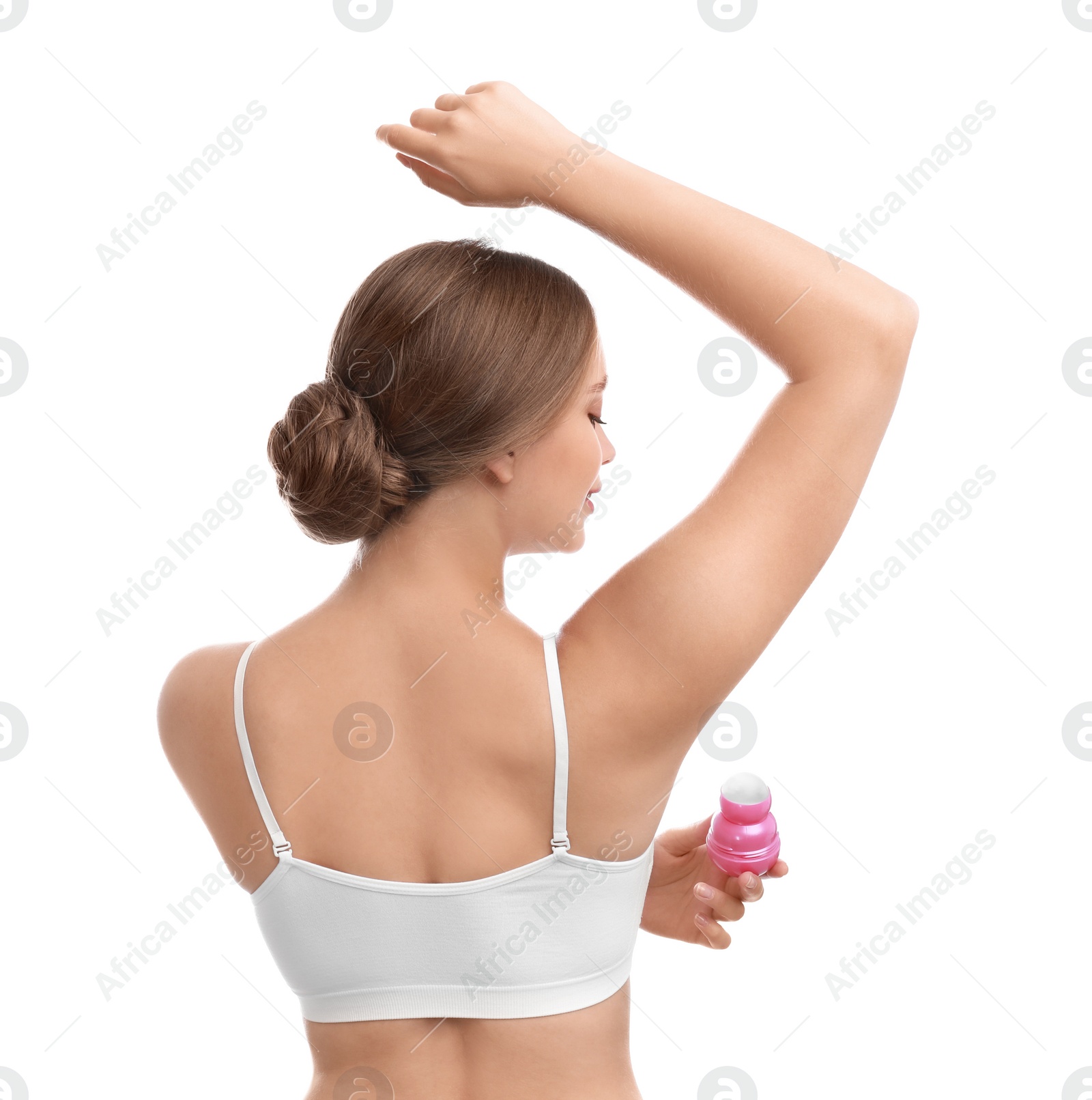Photo of Young woman applying deodorant to armpit on white background