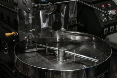 Photo of Stainless coffee roaster machine indoors. Modern device