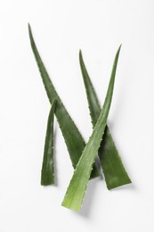 Photo of Green aloe vera leaves on white background, flat lay