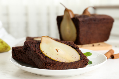 Photo of Tasty pear bread served with mint on white wooden table. Homemade cake