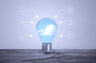 Image of Cloud technology concept. Light bulb with sky and different icons
